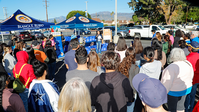 Group of people standing infront of Assemblywoman Rubio's popup tents at the 6th annual operation gobble turkey giveaway event